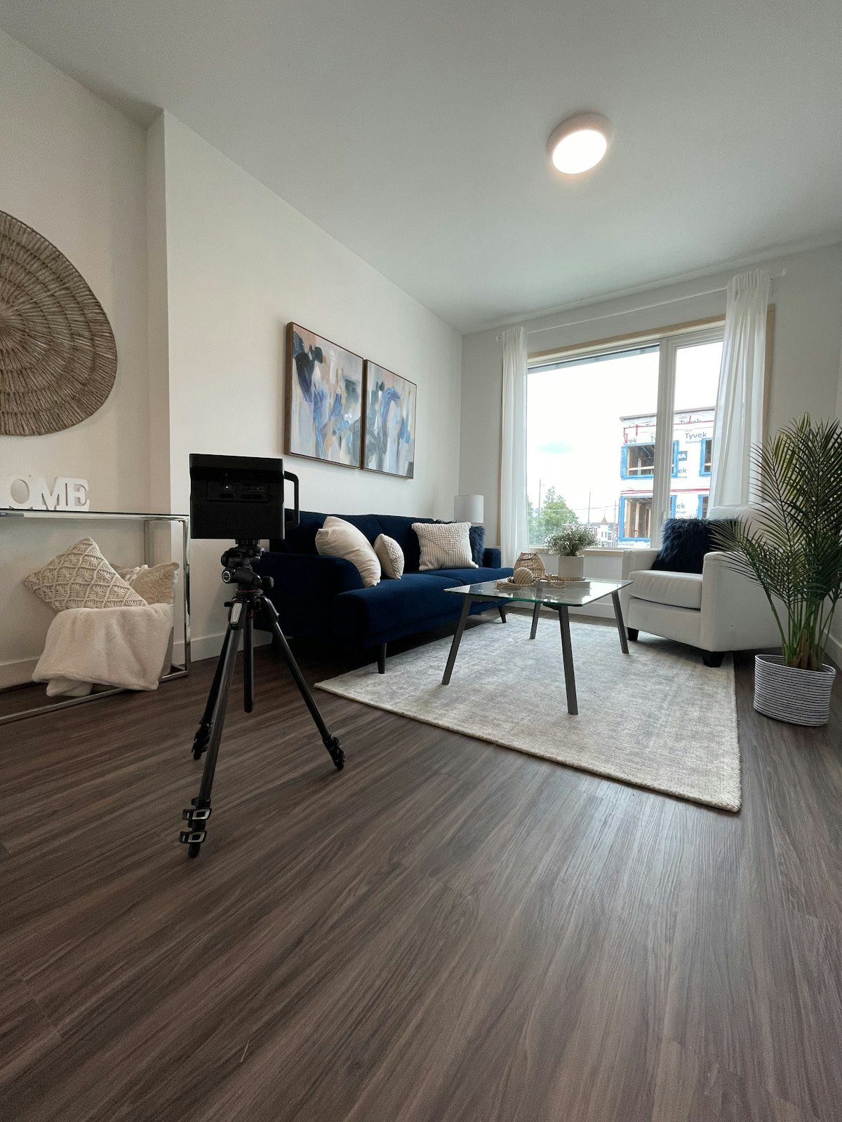 A Matterport camera on a tripod in a furnished flat